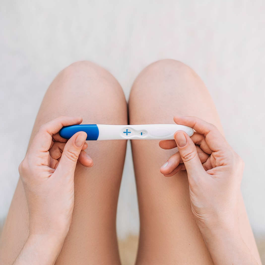 A woman holding a free pregnancy test in Bedford, Indiana